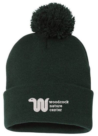 Product Description: Knit Forest Green Pom Beanie with White Logo. One size fits all. Pick up at Woodcock Nature Center</br> Green Pom Beanie with white logo